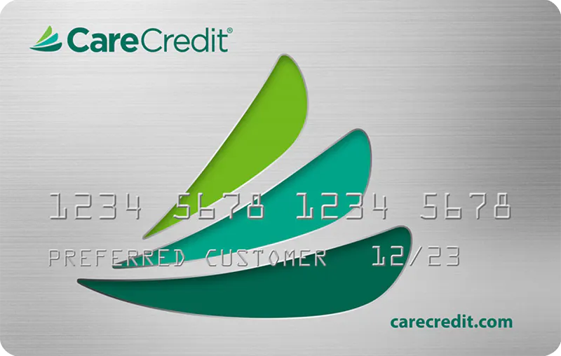CareCredit card with green and blue design on a gray background